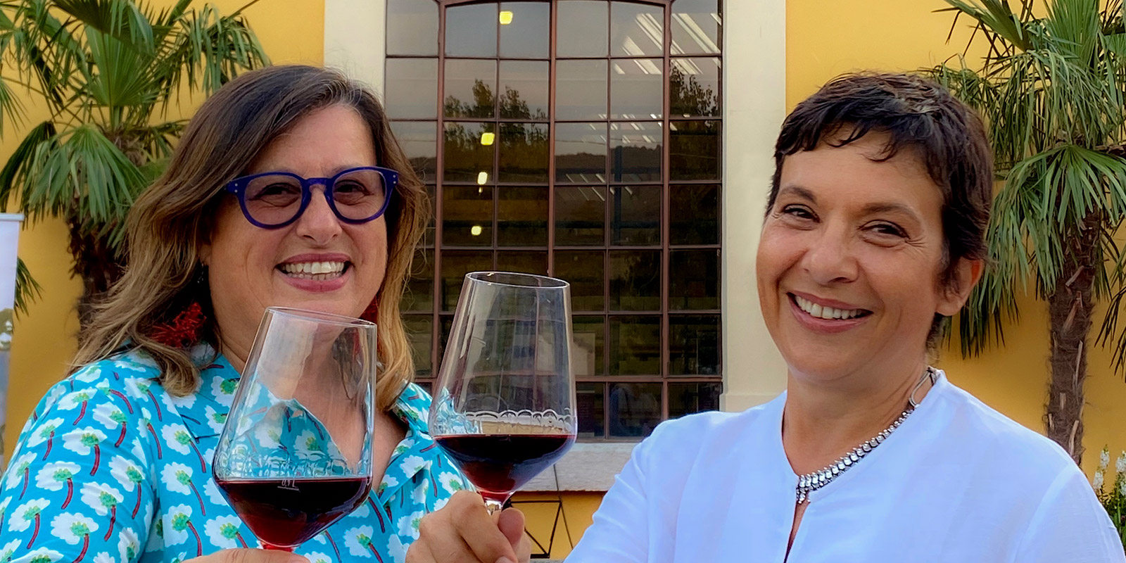 Antonia e Cristina Pavesi davanti al nuovo wine shop mentre degustano un Amarone nel calice